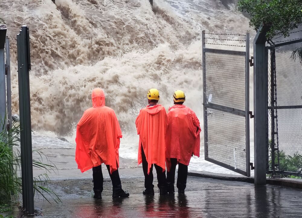 Floodwaters gush into a water-gathering area at Tai Shui Hang as rescuers search for a hiker, who was swept away near Hero Waterfall.SING TAO Floodwaters gush into a water-gathering area at Tai Shui Hang as rescuers search for a hiker, who was swept away near Hero Waterfall.SING TAO