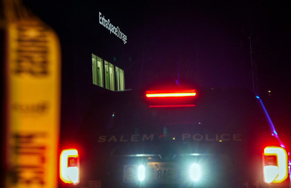 Photo by BING GUAN / AFP  A Salem Police Department cruiser is parked outside the storage facility where the suspect behind the mass shooting at Brown University was found dead, in Salem, New Hampshire, on December 19, 2025.