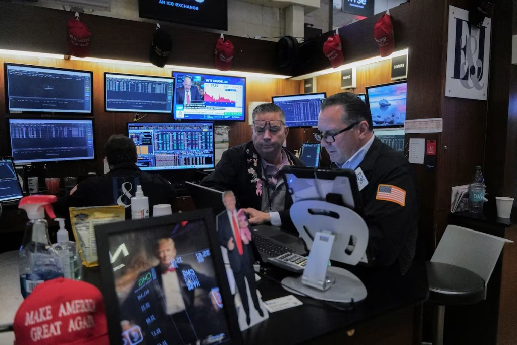 Traders work on the floor at the New York Stock Exchange (NYSE) in New York City, U.S., December 12, 2025. REUTERS