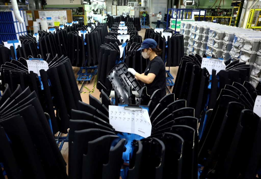 An employee works on the assembly line at Nanjo Auto Interior, a manufacturer of inside door panels and other parts for Mazda Motor, in Akitakata, Hiroshima Prefecture, Japan July 14, 2025. REUTERS