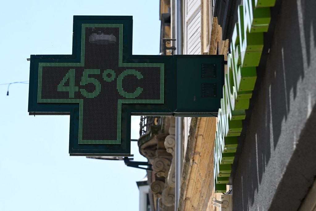 A pharmacy sign displays a temperature of 45 degrees Celsius in Thionville, north-eastern France, on July 2, 2025, as a heatwave hits Europe. Scientists estimated on September 17, 2025 that rising temperatures from human-caused climate change were responsible for roughly 16,500 deaths in European cities this summer, warning the true toll of this "silent killer" could be even higher. (Photo by Jean-Christophe VERHAEGEN / AFP)