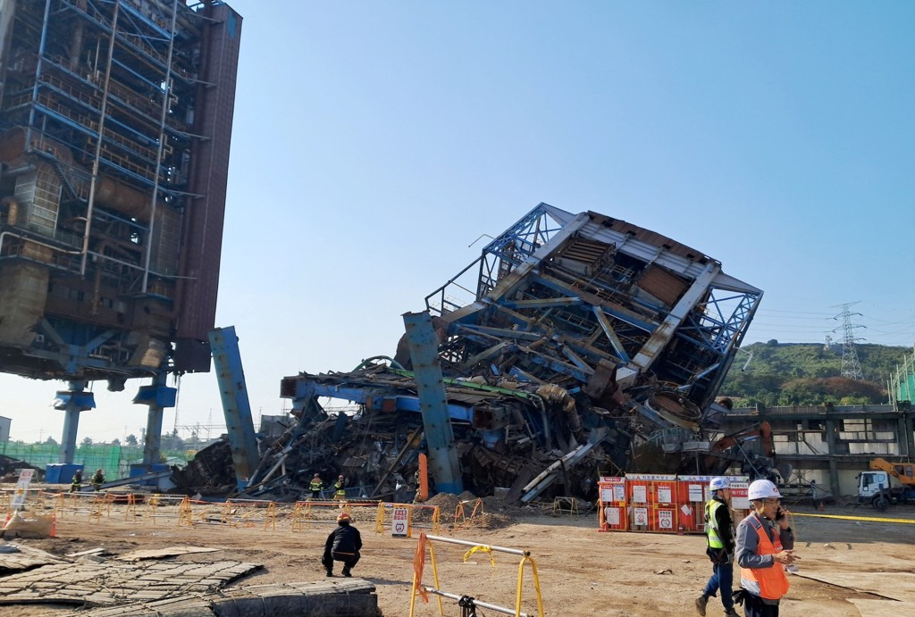 People walk near a large structure which collapsed and where multiple people are believed to be trapped, at the Korea East-West Power's Ulsan Power Plant headquarters, in Ulsan, South Korea, November 6, 2025. (Reuters)
