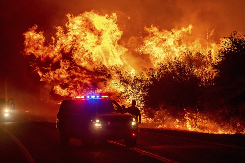 Flames lick above vehicles on Highway 162 as the Bear Fire burns in Oroville, California, on Wednesday. The blaze, part of the lightning-sparked North Complex, expanded at a critical rate of spread as winds buffeted the region. Flames lick above vehicles on Highway 162 as the Bear Fire burns in Oroville, California, on Wednesday. The blaze, part of the lightning-sparked North Complex, expanded at a critical rate of spread as winds buffeted the region.
