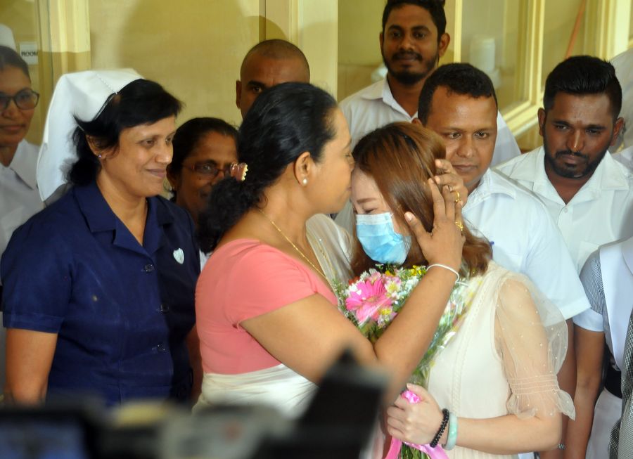 A Chinese coronavirus patient who was discharged is sent off with a kiss by Sri Lanka's Health Minister Pavithra Wanniarachchi in Colombo, Sri Lanka on February 19, 2020. She was Sri Lanka's first coronavirus patient. A Chinese coronavirus patient who was discharged is sent off with a kiss by Sri Lanka's Health Minister Pavithra Wanniarachchi in Colombo, Sri Lanka on February 19, 2020. She was Sri Lanka's first coronavirus patient.
