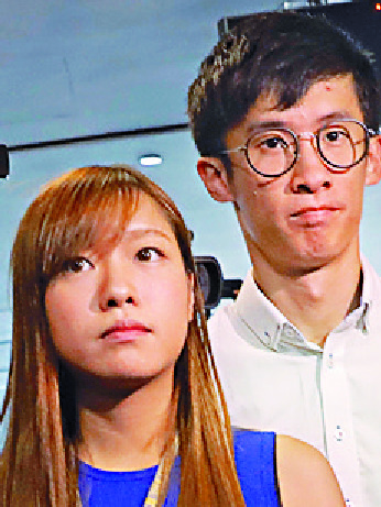 Sixtus Leung, seen with Yau Wai-ching, is said to have fled to the US. AP Sixtus Leung, seen with Yau Wai-ching, is said to have fled to the US. AP