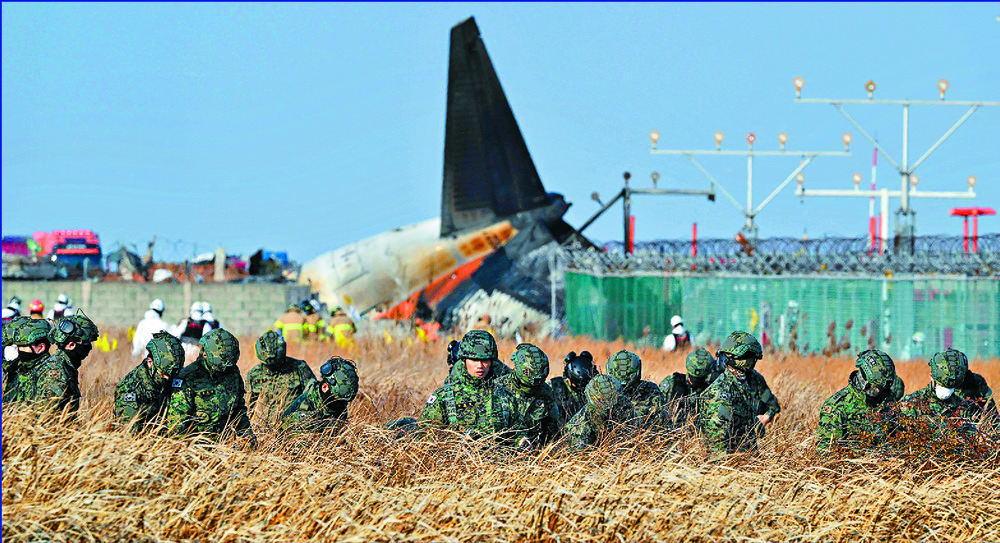 Soldiers look for the missing, burned-out seats are lifted and rescuers inspect debris. AFP, REUTERS, AP