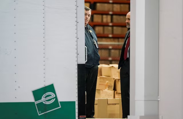 Members of the Federal Bureau of Investigation (FBI) stand inside a vehicle loaded with boxes outside the Fulton County Election Hub and Operation Center after the FBI executed a search warrant there in relation to the 2020 election, according to a law enforcement official familiar with the matter, in Union City, Georgia, U.S. January 28, 2026. REUTERS/Elijah Nouvelage/File Photo