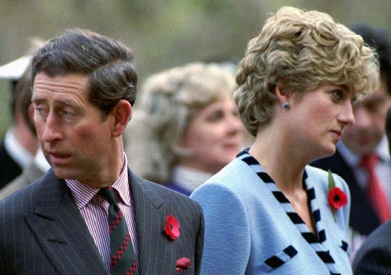Princess Diana and Prince Charles look in different directions during a Korean War commemorative service in November 1992. REUTERS/Stringer. 