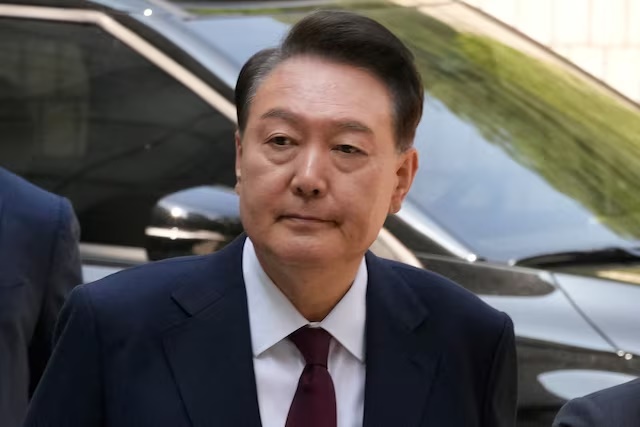 South Korea's ousted President Yoon Suk Yeol, who is facing charges of orchestrating a rebellion when he declared martial law, arrives to attend his trial at the Seoul Central District Court in Seoul, South Korea, Monday, May 12, 2025. Ahn Young-joon/Pool via REUTERS/File Photo