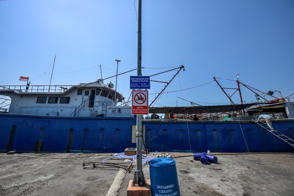 Photo by BAY ISMOYO / AFP  This picture taken on June 11, 2026 shows crew members working on a fishing vessel at the Nusantara Fishing Port in Kejawan-Cirebon, West Java.