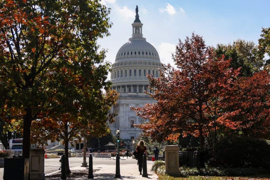 The U.S. Capitol building is framed between trees with fall foliage, weeks into the continuing U.S. government shutdown, in Washington, D.C., U.S., October 27, 2025. REUTERS/Kylie Cooper/File Photo
