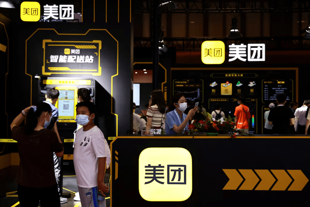 Visitors stand near a booth of Meituan at the 2022 World Robot Conference in Beijing, China August 18, 2022. REUTERS/Tingshu Wang/File Photo 