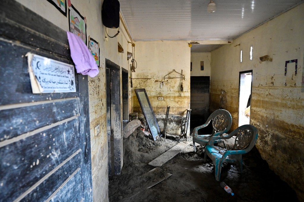 Photo by CHAIDEER MAHYUDDIN / AFP  An aerial view shows flood damage to the interior of a house in Meurah Dua, Aceh province's Pidie Jaya district on February 21, 2026, after devastating floods and landslides struck Indonesia's Sumatra late last year.