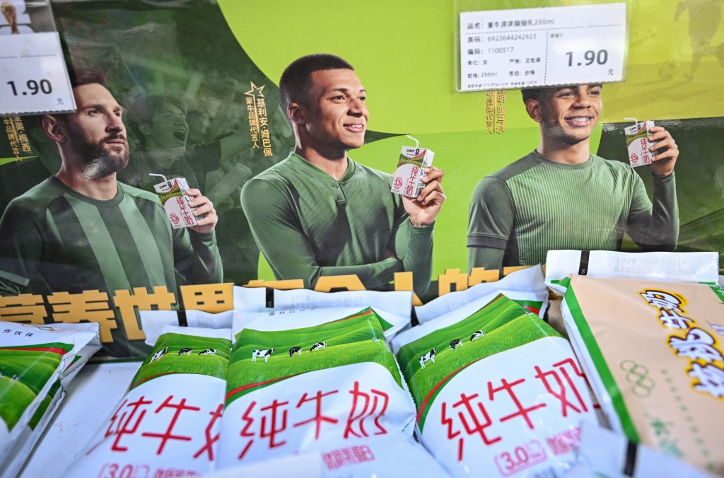 Photo by PEDRO PARDO / AFP This photo shows an advertising campaign for Chinese dairy brand 'Mengniu' featuring football stars France's Kylian Mbappe (C), Argentina's Lionel Messi (L) and Spain's Lamine Yamal at a supermarket in Beijing on October 28, 2026.