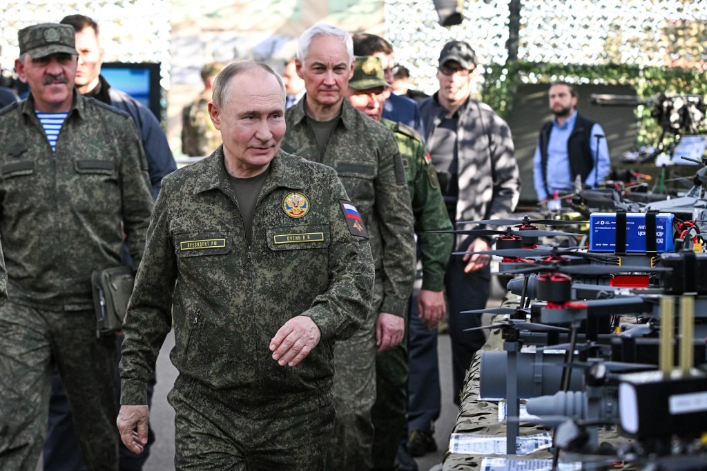 Russian President Vladimir Putin accompanied by Deputy Defence Minister Yunus-Bek Yevkurov, left, and Defence Minister Andrei Belousov, right, inspects Russian weapons and equipment during his visit to the Russian-Belarusian joint military drills "Zapad 2025" (West 2025) at the Mulino training ground in Nizhny Novgorod region, Russia, Tuesday, Sept. 16, 2025. (Sergey Bobylev/Sputnik, Kremlin Pool Photo via AP)