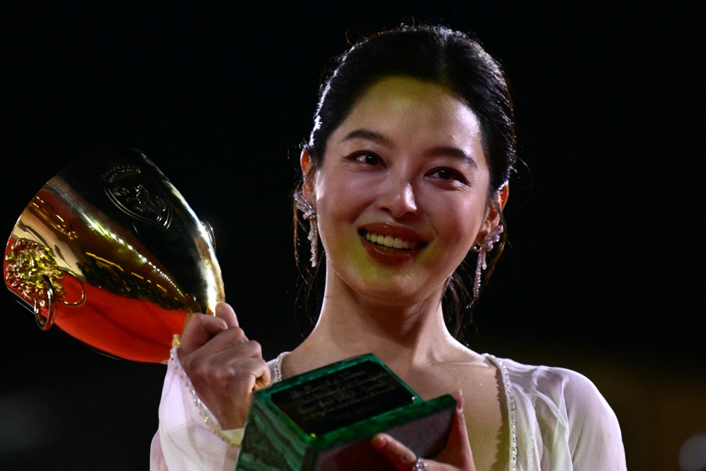 Chinese actress Xin Zhilei poses with the Coppa Volpi for Best Actress she received. (AFP)