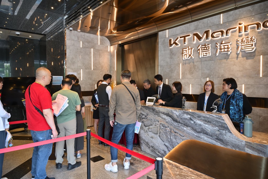 Visitors line up outside of the KT Marina II sales office