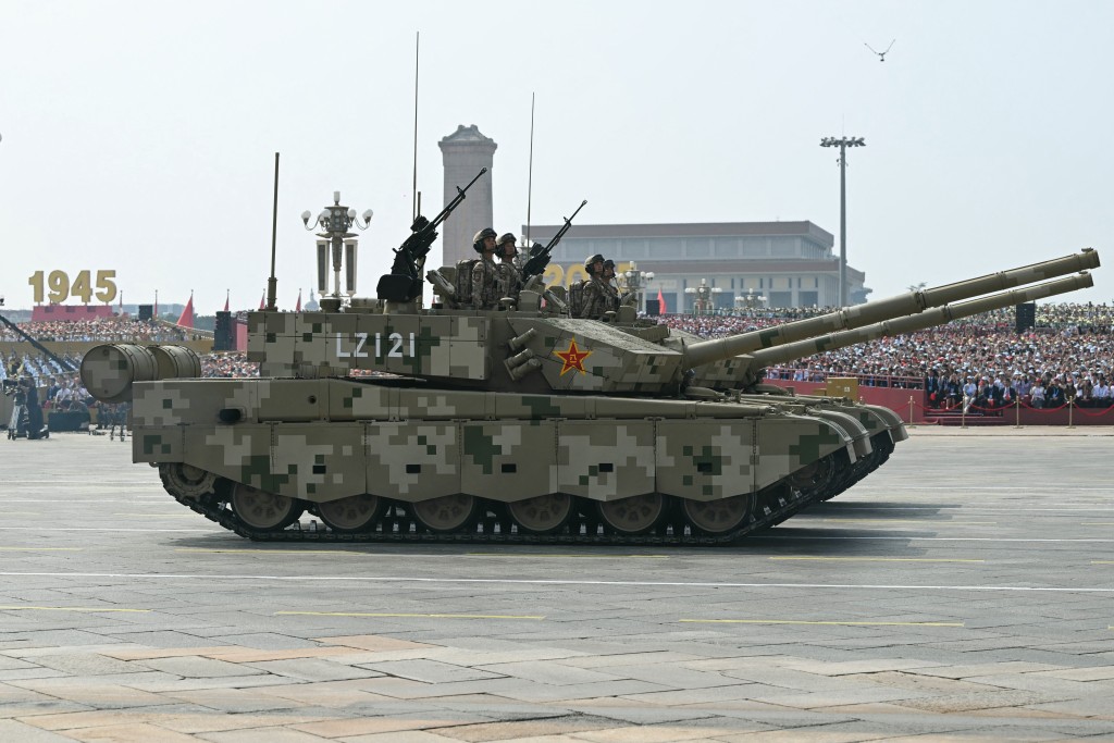 Officers are seen in the hatch of a Type 99 main battle tank as it roll during a military parade marking the 80th anniversary of victory over Japan and the end of World War II, in Beijing’s Tiananmen Square on September 3, 2025. (AFP)