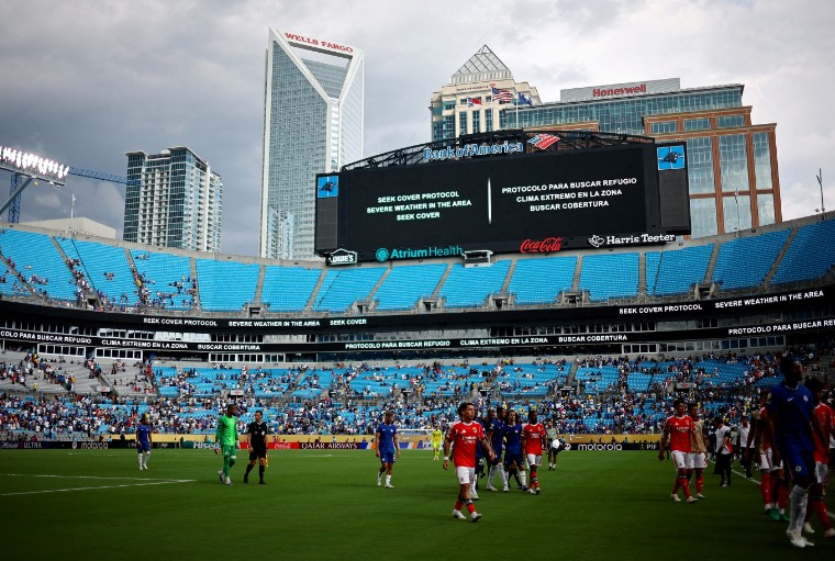 Players  walk off the pitch after referee Slavko Vincic signals a weather delay in the second half of the match. (Reuters)