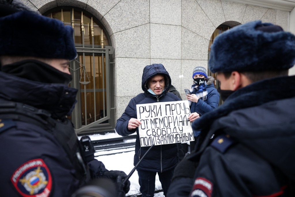 Photo by DIMITAR DILKOFF / AFP  A man holding a placard reading "Hands off Memorial.