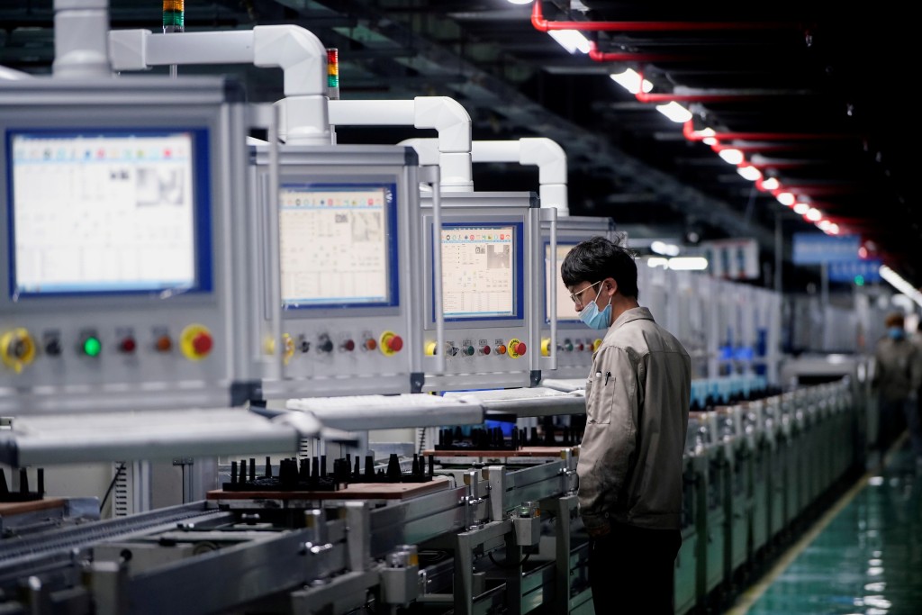 An employee works on the production line of electric vehicle (EV) battery manufacturer Octillion in Hefei, Anhui province, China March 30, 2021. Picture taken March 30, 2021. REUTERS
