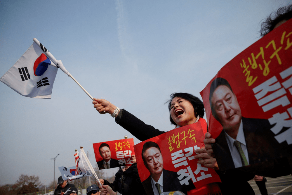 A supporter of South Korean impeached President Yoon Suk Yeol cheers after the court decided to release him, in front of the Seoul detention center in Uiwang, South Korea, March 7, 2025. REUTERS/Kim Hong-j A supporter of South Korean impeached President Yoon Suk Yeol cheers after the court decided to release him, in front of the Seoul detention center in Uiwang, South Korea, March 7, 2025. REUTERS/Kim Hong-j