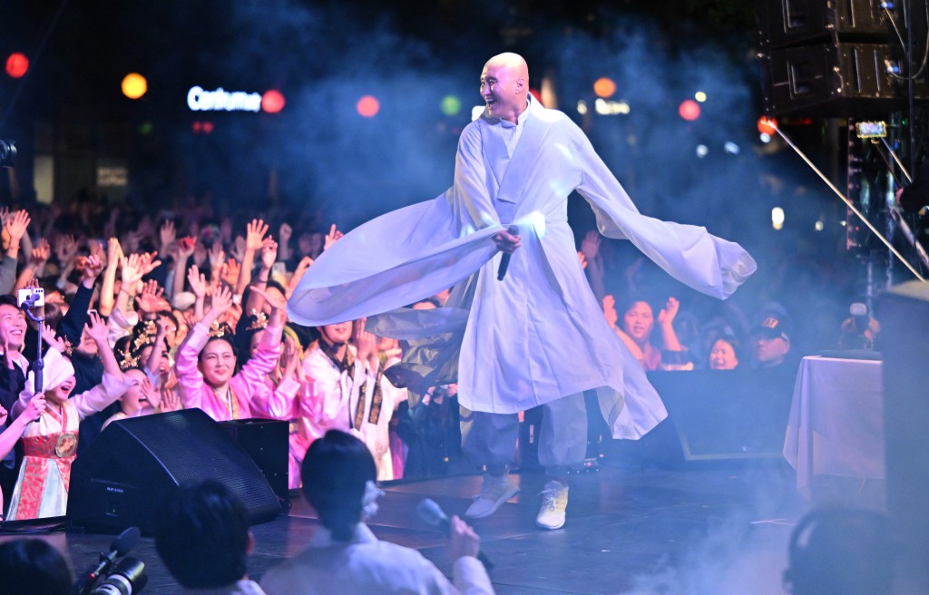 Yoon Seong Ho, known as NewJeansNim, performs wearing a traditional Buddhist robe. AFP Yoon Seong Ho, known as NewJeansNim, performs wearing a traditional Buddhist robe. AFP