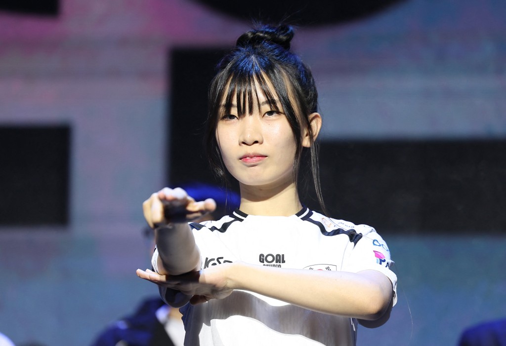 Photo by - / YONHAP / AFP  This picture taken on August 25, 2026 shows Park So-yeon, who will compete in the survival horror game Identity V at the Asian Games, posing during the launch ceremony of the South Korean national eSports team for the Aichi–Nagoya Asian Games, in Seoul.