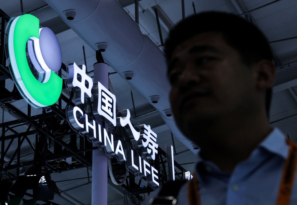 A man passes by a logo of China Life Insurance Company ltd at its booth at China International Fair for Trade in Services (CIFTIS) in Beijing, China, September 10, 2025. REUTERS