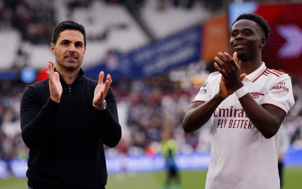 Bukayo Saka, with Mikel Arteta, relished Arsenal's successful campaign. REUTERS