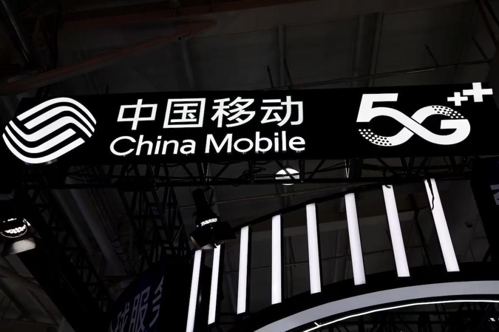 A sign for China Mobile is pictured next to a 5G sign during the 2022 China International Fair for Trade in Services (CIFTIS) in Beijing, China September 1, 2022. REUTERS