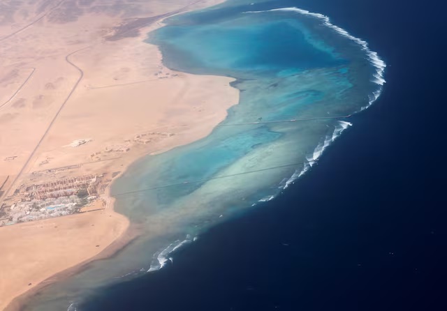 An aerial view shows the coast of the Red Sea, through the window of a plane before landing, in Marsa Alam, Egypt March 23, 2025. REUTERS/Stringer