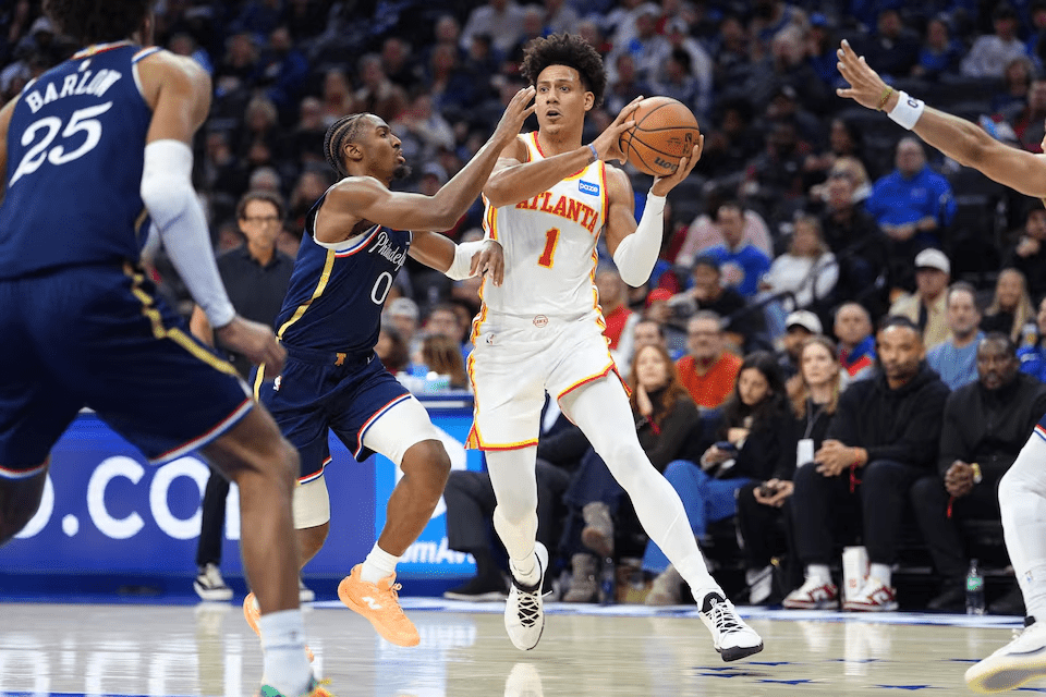 Nov 30, 2025; Philadelphia, Pennsylvania, USA; Atlanta Hawks forward Jalen Johnson (1) drives against Philadelphia 76ers guard Tyrese Maxey (0) in the second quarter at Xfinity Mobile Arena. Mandatory Credit: Kyle Ross-Imagn Image
