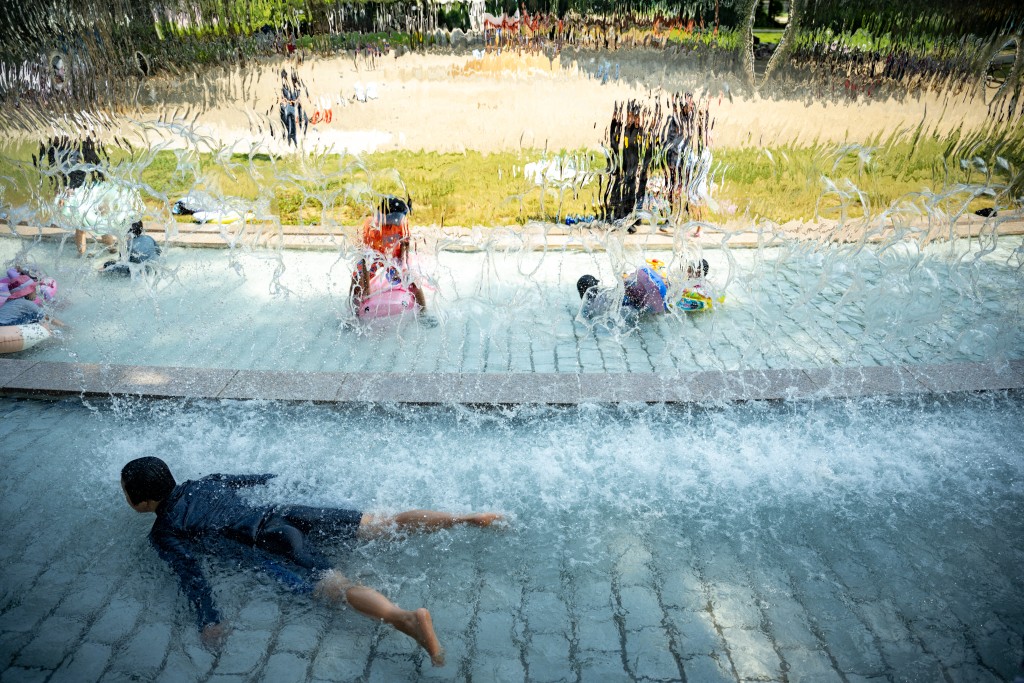 Photo by PHILIP FONG / AFP  Children cool off in a public water playground at a park in Edogawa district of Tokyo on July 23, 2026.