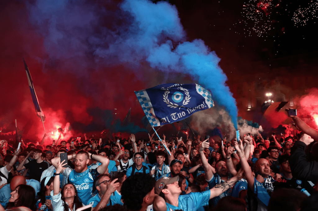 Napoli fans celebrate their first goal scored by Scott McTominay as they watch the match in the Piazza del Plebiscito in Naples. (REUTERS/Yara Nardi)