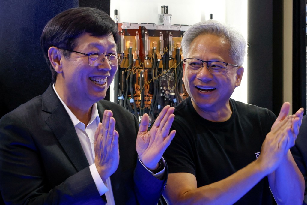 Foxconn Chairman Young Liu and Nvidia's CEO Jensen Huang react at Foxconn booth at Computex in Taipei, Taiwan May 20, 2025. REUTERS