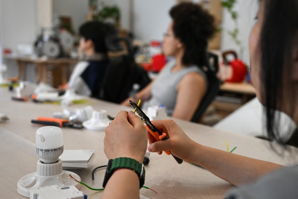 Photo by PEDRO PARDO / AFP  This picture taken on June 28, 2026 shows women attending an electricity course at the Mulan Build workshop in Hangzhou, in eastern China's Zhejiang province.