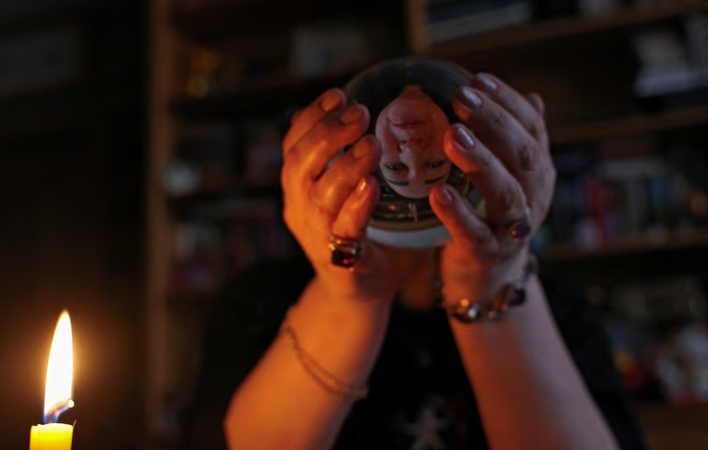 Natalia Malinovskaya, a self-described witch, holds a crystal ball during an interview with Reuters at her apartment in Moscow, Russia February 17, 2026. REUTERS/Ramil Sitdikov