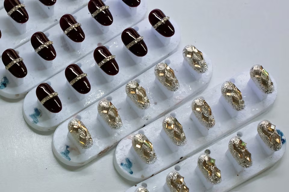 Finished press-on nails on the production line at Donghai Yizhigu Nail Art factory in Donghai county, Lianyungang, Jiangsu province, China September 17, 2026. REUTERS/Chenxi Yang