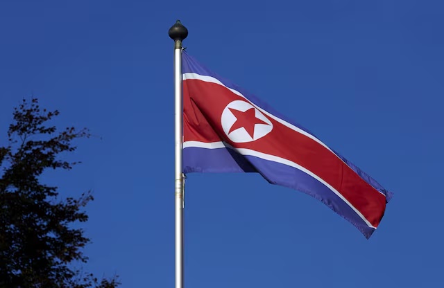 FILE PHOTO - A North Korean flag flies on a mast at the Permanent Mission of North Korea in Geneva October 2, 2014. REUTERS/Denis Balibouse 