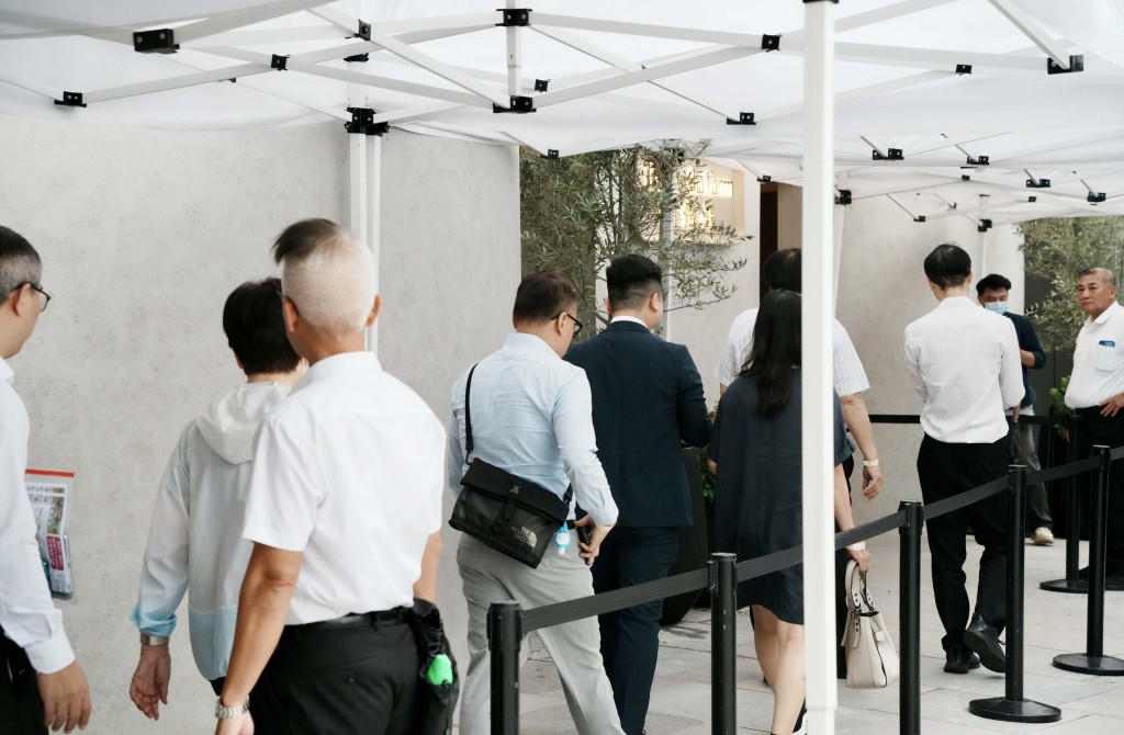 Visitors line up outside of the Pavilia Farm III's sales office