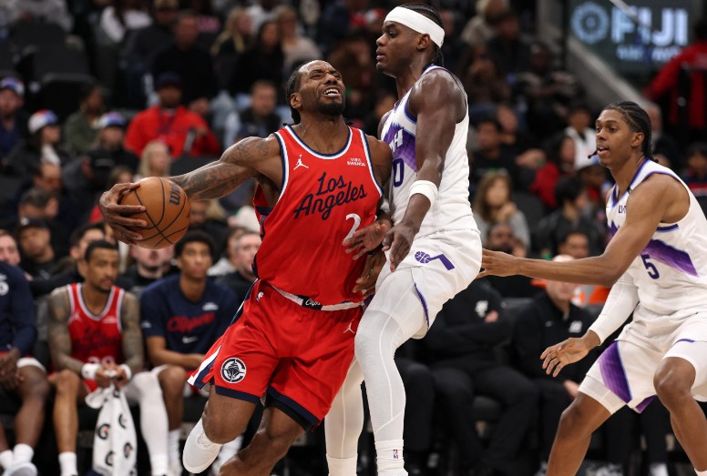 Kawhi Leonard is fouled by Utah Jazz forward Taylor Hendricks.  REUTERS