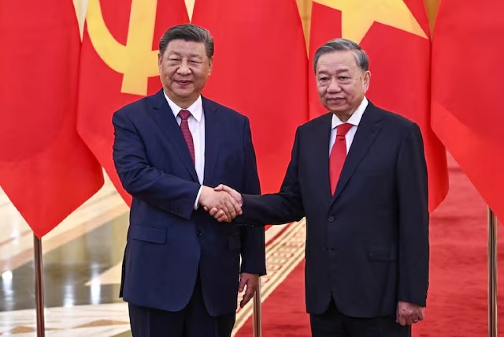 Vietnam's communist party general secretary To Lam (R) shakes hands with Chinese President Xi Jinping (L) during a meeting at the office of the Party Central Committee in Hanoi on April 14, 2025. NHAC NGUYEN/Pool via REUTERS/File Photo 