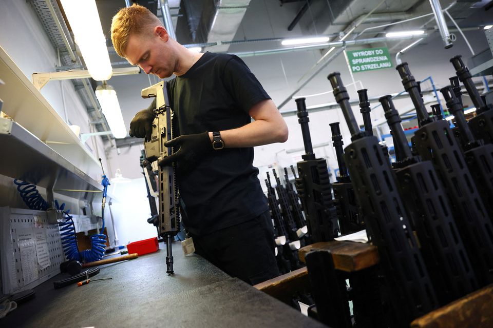 A worker checks the quality of firing of GROT C16 FB-M1, modular assault rifle system at PGZ (Polska Grupa Zbrojna) arms factory Fabryka Broni Lucznik in Radom Poland. (Reuters) 