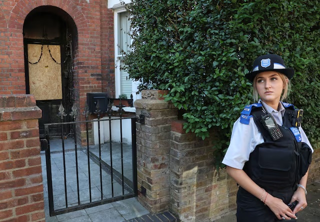 A police officer stands outside Britain's Prime Minister Keir Starmer's private home, after it was damaged by fire in a suspected arson attack in north London, Britain, May 13, 2025. REUTERS/Toby Melville/File Photo 