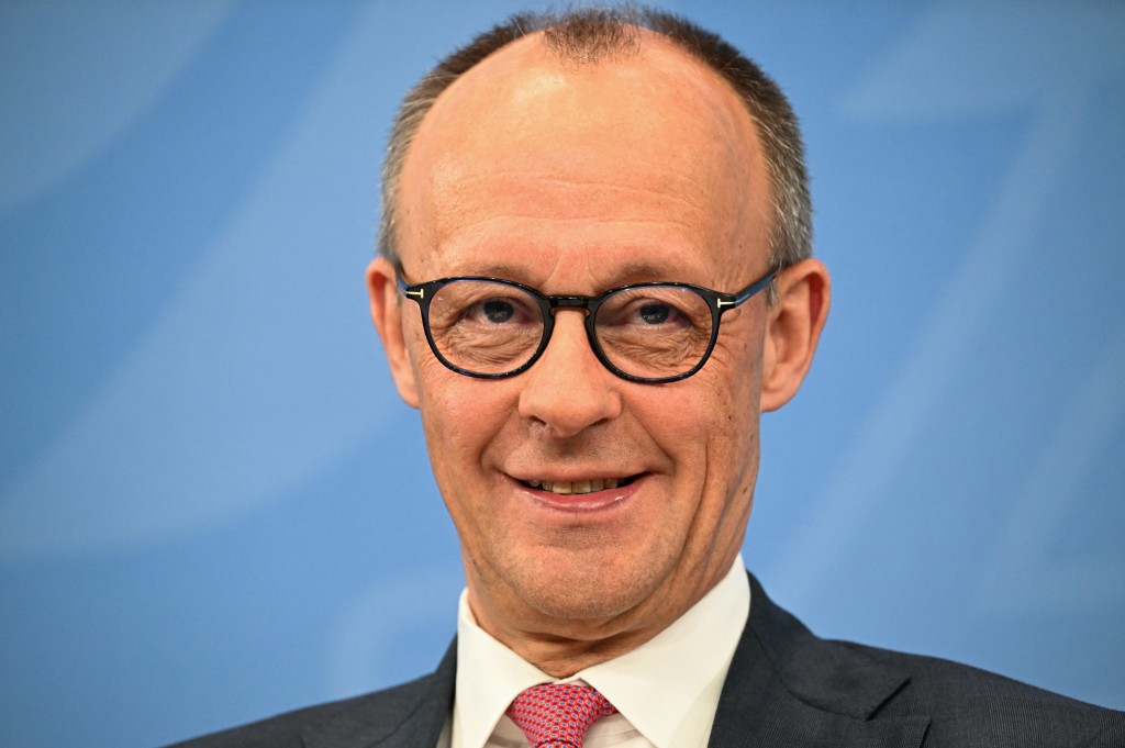 German Chancellor Friedrich Merz smiles prior to a press briefing on the results of overnight coalition committee consultations, on April 13, 2026 at the Chancellery in Berlin. (AFP)