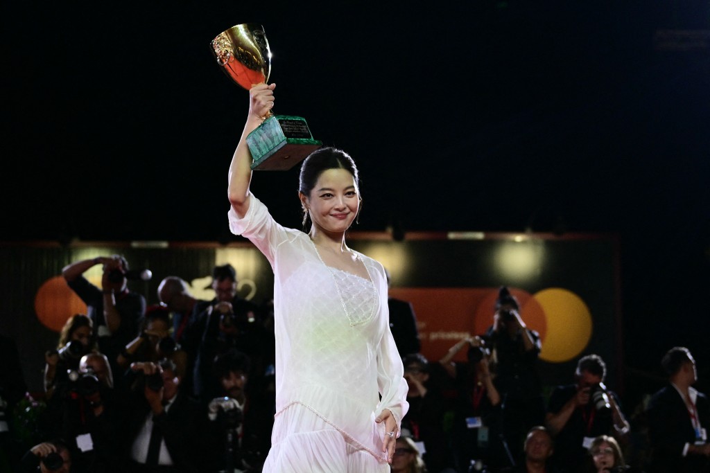 Chinese actress Xin Zhilei poses with the Coppa Volpi for Best Actress she received. (AFP)