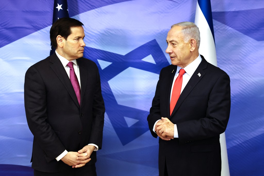 US Secretary of State Marco Rubio (L) looks on as Israel's Prime Minister Benjamin Netanyahu speaks following their meeting at the Prime Minister's office in Jerusalem on October 23, 2025. Rubio voiced confidence on October 23 in maintaining and expanding a Gaza truce deal as he met Israeli Prime Minister Benjamin Netanyahu. (Photo by Fadel SENNA / AFP) (Photo by FADEL SENNA / POOL / AFP)