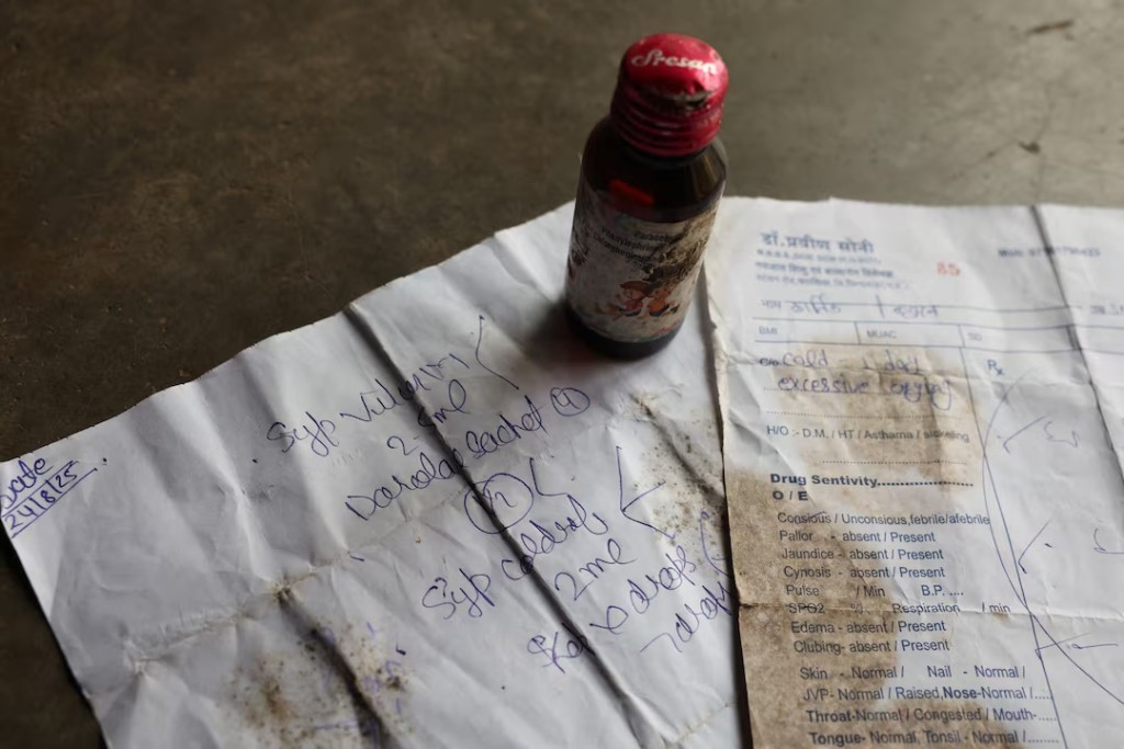 A bottle of Coldrif cough syrup and a prescription which Reema Yaduvanshi, 26, received from doctor Praveen Soni for her six-month-old son Kartik, in Parasia, Madhya Pradesh, India, October 10, 2025. The syrup was later banned, after it was linked to the deaths of multiple children, and is being recovered by community healthcare workers amid a door-to-door campaign to spread awareness and recall it. REUTERS/Priyanshu Singh