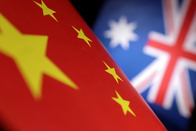 Printed Chinese and Australian flags are seen in this illustration, July 21, 2022. REUTERS/Dado Ruvic/Illustration/File Photo 